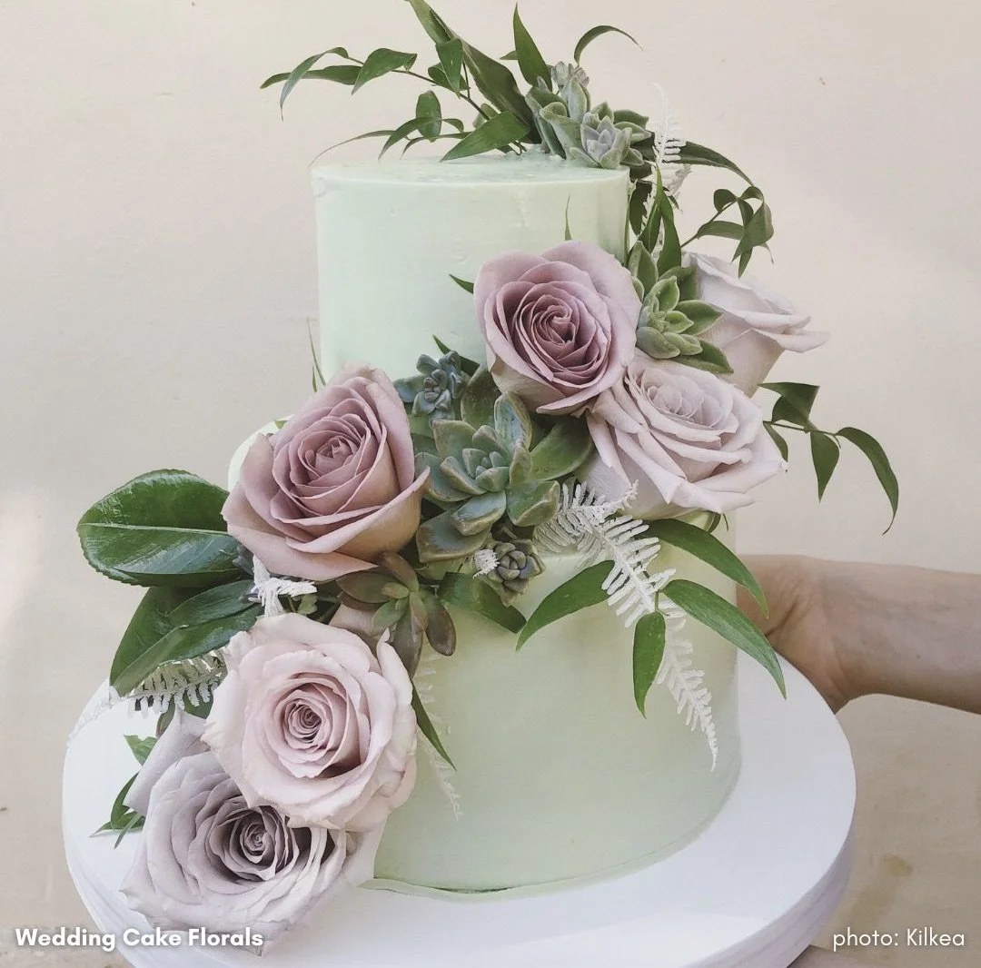 Wedding cake dressed with roses and greenery by Kilkea Design